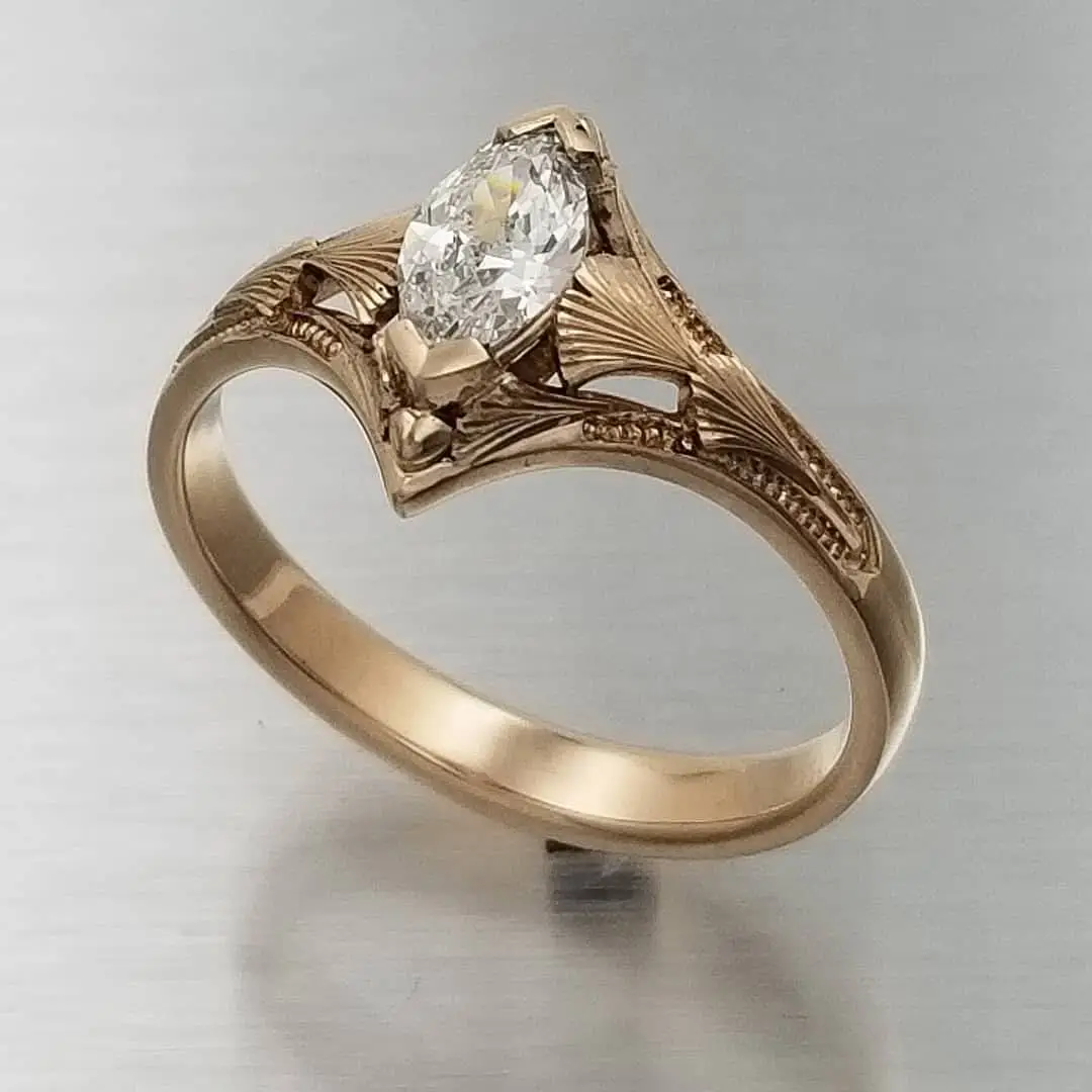 Engraved and sculpted Ginkgo Leaves accent the center diamond