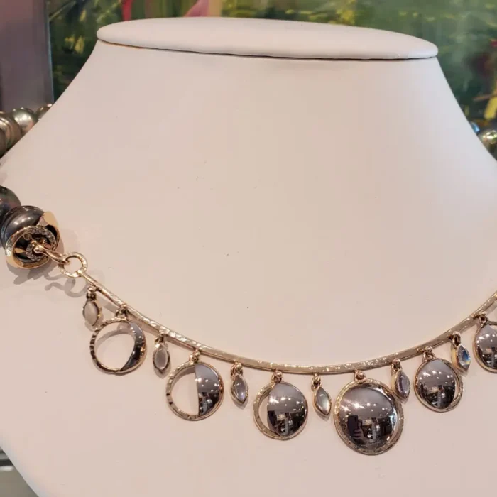Crafted in 18 K Palladium White Gols and Featuring Tahitian Pearls , Marquise Moonstones, and the phases of the moon